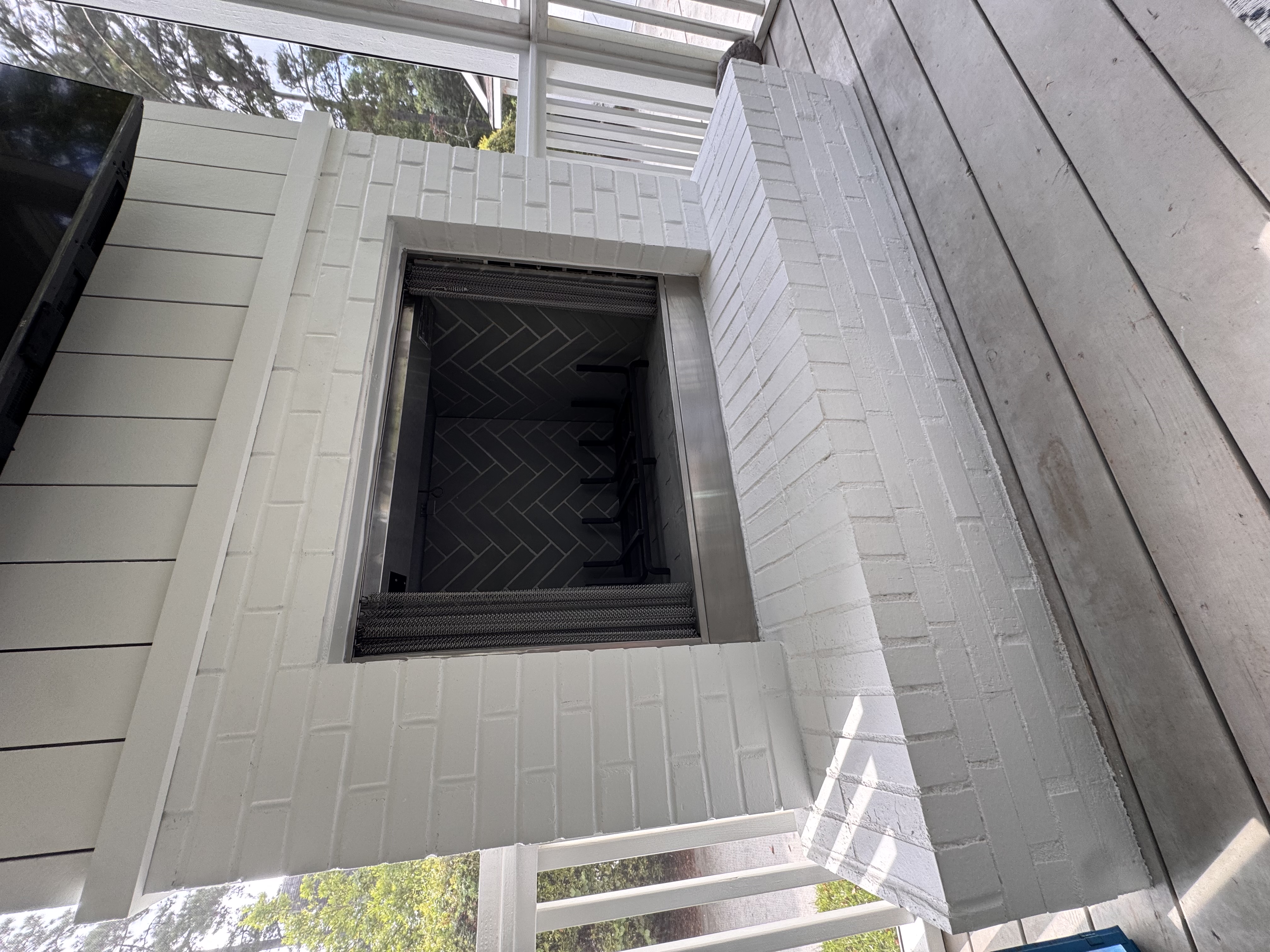 Custom outdoor fireplace and privacy wall detail for a Lowcountry backyard